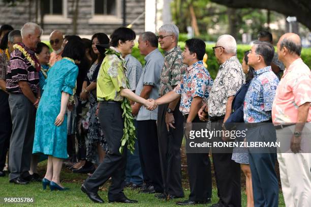 Prince Akishino of Japan and his wife Princess Kiko greet members of the community as they arrive for a tree planting ceremony at Thomas Square Park...