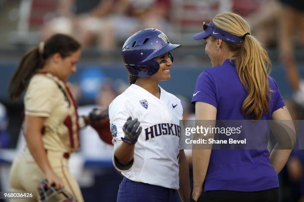 Taryn Atlee of the Washington Huskies talks with Head Coach Heather Tarr against the Florida State Seminoles during the Division I Women's Softball...
