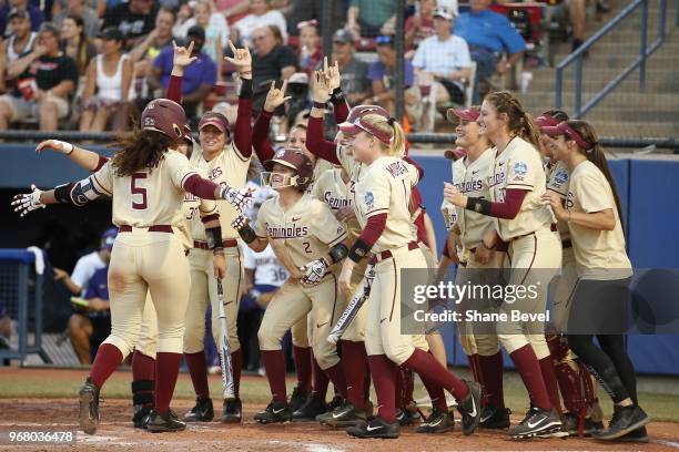 Elizabeth Mason of the Florida State Seminoles celebrates after a home run against the Washington Huskies during the Division I Women's Softball...