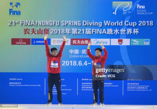 Gold medalists Cao Yuan of China and Xie Siyi of China pose on the podium after winning the Men's 3m Synchro Springboard final on day one of the 21st...