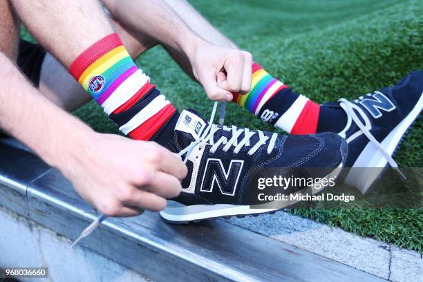 Hunter Clark shows off his Pride Game socks during a We Are Pride Cup Launch press conference at AFL House on June 6, 2018 in Melbourne, Australia.