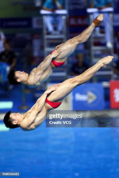 Cao Yuan of China and Xie Siyi of China compete in the Men's 3m Synchro Springboard final on day one of the 21st FINA Diving World Cup 2018 at...