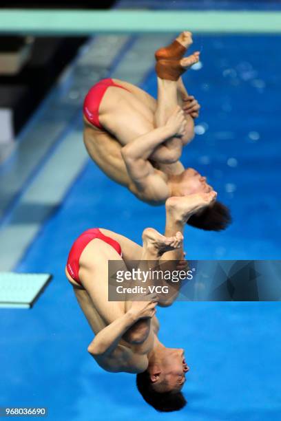 Cao Yuan of China and Xie Siyi of China compete in the Men's 3m Synchro Springboard final on day one of the 21st FINA Diving World Cup 2018 at...