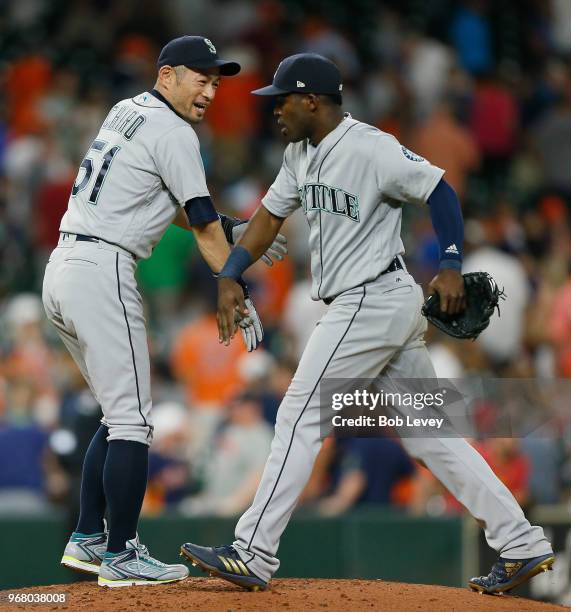 Ichiro Suziki of the Seattle Mariners shakes hands with Guillermo Heredia after the final out against the Houston Astros at Minute Maid Park on June...