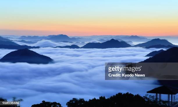 Photo taken from Mt. Kiro in the western Japan city of Imabari, Ehime Prefecture, at dawn on May 24 shows a sea of clouds covering small islands in...