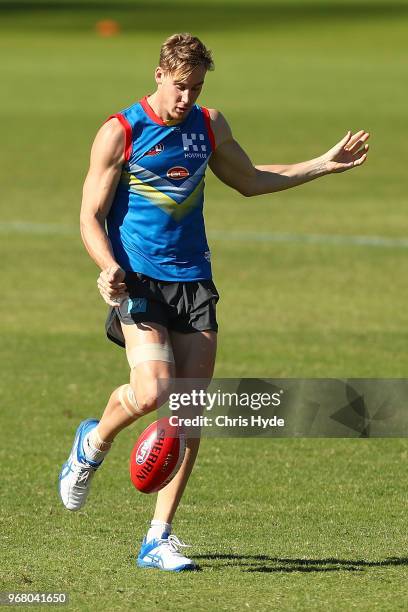 Tom Lynch kicks during a Gold Coast Suns AFL training session at Metricon Stadium on June 6, 2018 in Gold Coast, Australia.