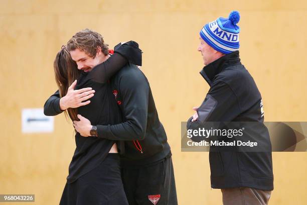 Legend Neale Daniher watches Joe Daniher of the Bombers hug his daughter Bec during an Essendon Bombers AFL media opportunity at The Hangar on June...