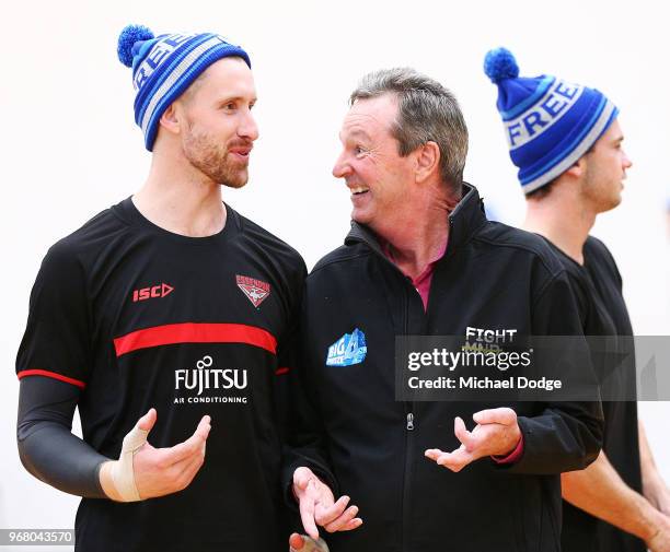 Legend Neale Daniher speaks to Shaun McKernan of the Bombers as he arrives to speak to media during an Essendon Bombers AFL media opportunity at The...