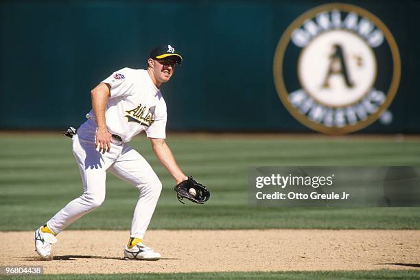 Scott Spiezio of the Oakland Athletics fields an infield ball during an MLB game against the Cleveland Indians on April 3, 1997 at Oakland-Alameda...