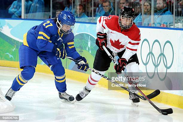 Meghan Agosta of Canada is challenged by Emma Nordin ofSweden during the ice hockey women's preliminary game between Canada and Sweden on day 6 of...