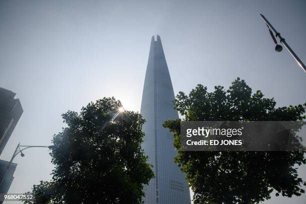 General view shows the Lotte World Tower in Seoul on June 6, 2018. - French "Spiderman" Alain Robert, who holds a world record for urban climbing,...