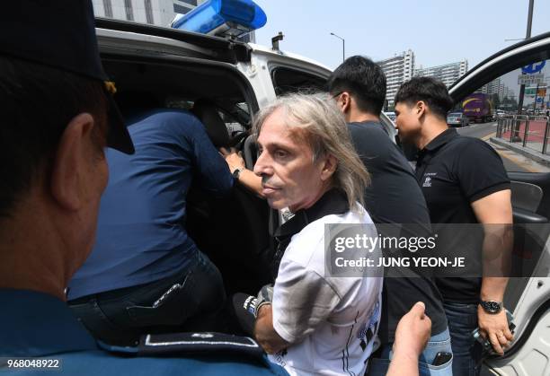 French urban climber Alain Robert is arrested after being intercepted during his climb of the Lotte World Tower in Seoul on June 6, 2018. - French...