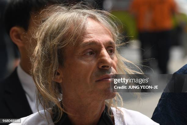 French urban climber Alain Robert is arrested after being intercepted during his climb of the Lotte World Tower in Seoul on June 6, 2018. - French...