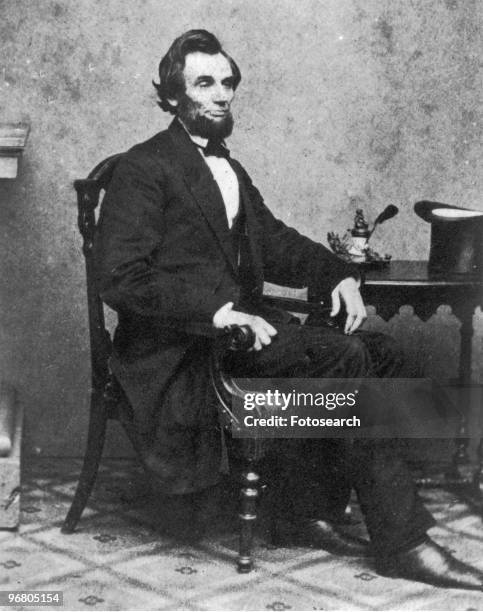 Portrait of President Abraham Lincoln sitting at a desk, February 24, 1861. .