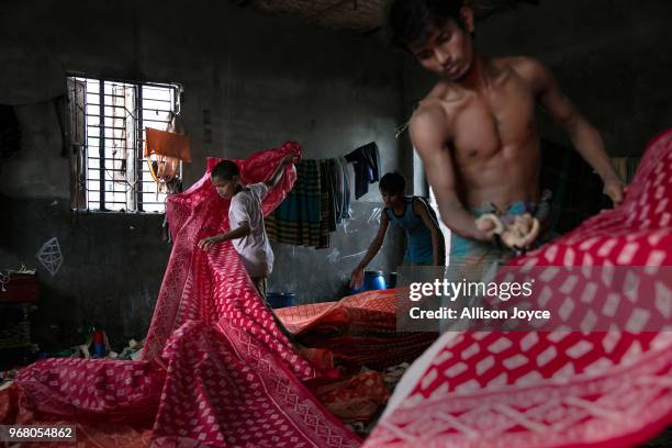 People work in a dying factory in Shyampur, whose waste is dumped into the Buriganga river, on June 4, 2018 in Dhaka, Bangladesh. Bangladesh has been...