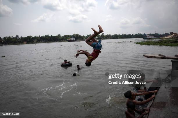 Child dives into the Buriganga river on June 3, 2018 in Dhaka, Bangladesh. Bangladesh has been reportedly ranked 10th out of the top 20 plastic...