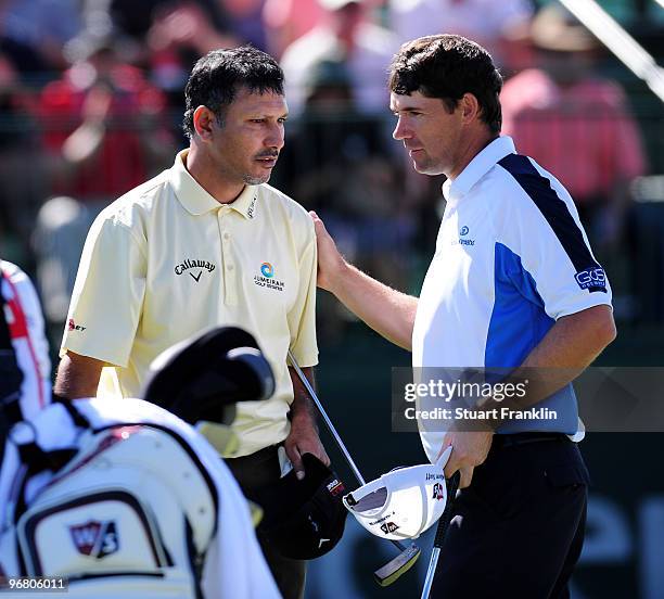 Padraig Harrington of Ireland and Jeev Milkha Singh of India shake hands on the 17th hole during round one of the Accenture Match Play Championship...