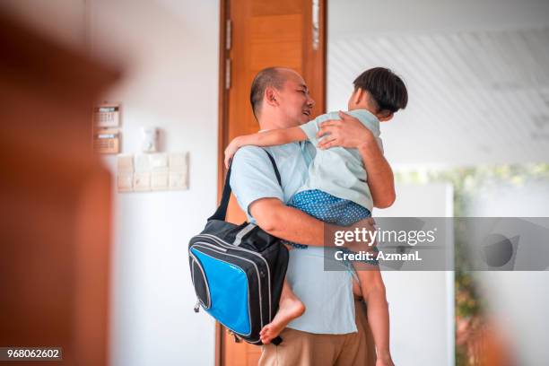 father hugging son when coming home - hitting enter stock pictures, royalty-free photos & images