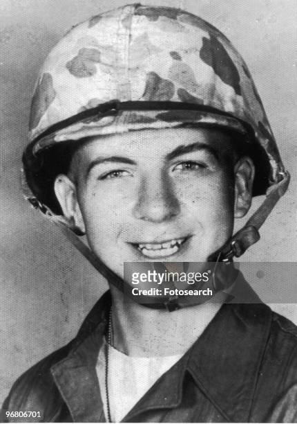 Portrait of Lee Harvey Oswald wearing an army helmet, circa 1960s. .