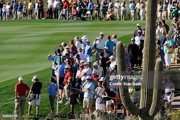 Fans watch play from the 18th hole during the first round of the World Golf Championships-Accenture Match Play Championship at The Ritz-Carlton Golf...
