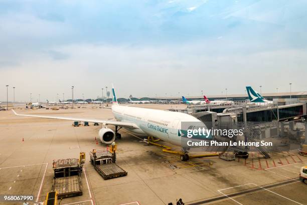 cathay pacific airplanes parking at hong kong international airport - a320 turbine engine stock pictures, royalty-free photos & images