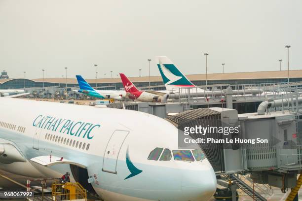 cathay pacific airplanes parking at hong kong international airport - a320 turbine engine stock pictures, royalty-free photos & images