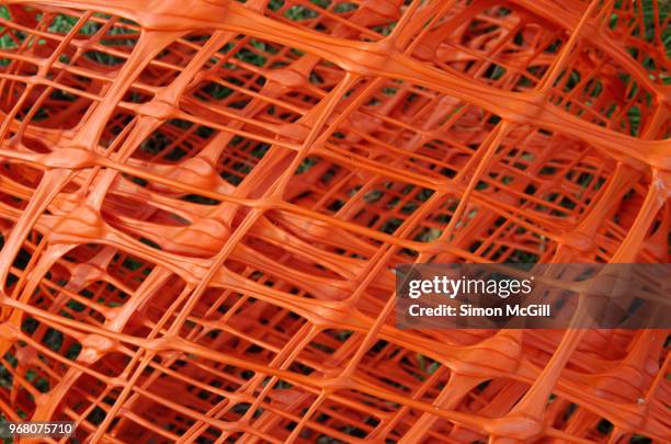 roll of orange plastic safety barrier mesh - construction barrier stock pictures, royalty-free photos & images