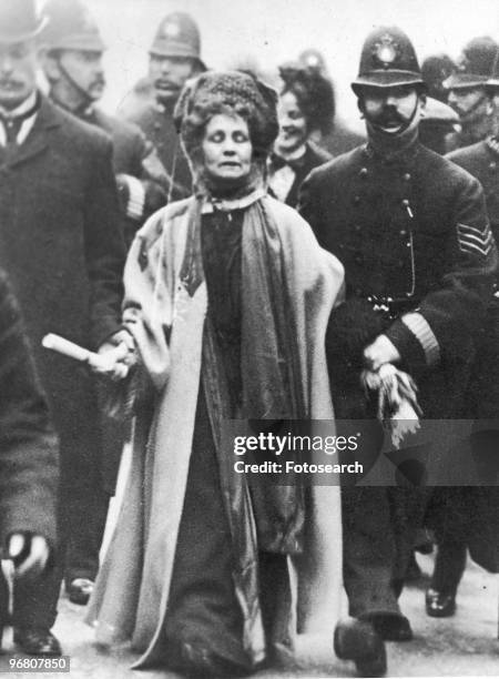 Emmeline Pankhurst surrounded by police officers, circa 1900s. .