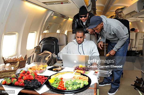 Carmelo Anthony and Chauncey Billups watch the computer of Arron Afflalo of the Denver Nuggets prior to the flight to Cleveland on February 17, 2010...