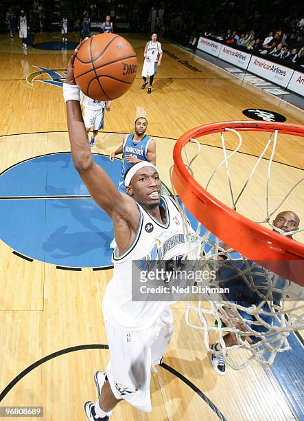 Josh Howard of the Washington Wizards dunks against Damien Wilkins of the Minnesota Timberwolves at the Verizon Center on February 17, 2010 in...