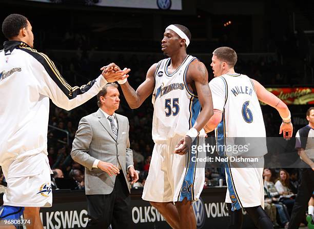 Josh Howard and JaVale McGee of the Washington Wizards celebrate a made basket during a timeout against the Minnesota Timberwolves at the Verizon...