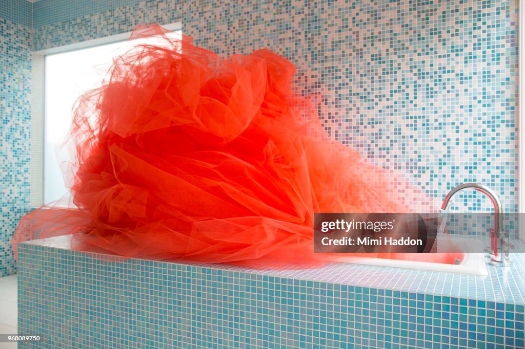 Designer Bathtub Filled with Bright Orange Fabric