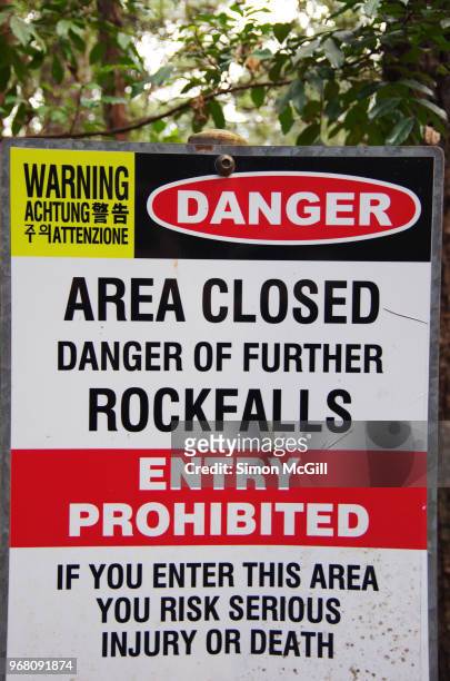 sign in bush land warning 'danger: area closed. danger of further rockfalls. entry prohibited. if you enter this area you risk serious injury or death.' - closed until further notice stock pictures, royalty-free photos & images