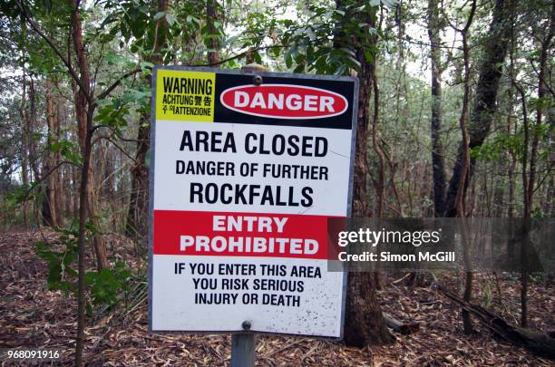 sign in bush land warning 'danger: area closed. danger of further rockfalls. entry prohibited. if you enter this area you risk serious injury or death.' - closed until further notice stock pictures, royalty-free photos & images