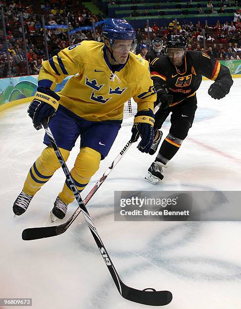 Samuel Pahlsson of Sweden moves the puck against Germany during the ice hockey men's preliminary game on day 6 of the Vancouver 2010 Winter Olympics...
