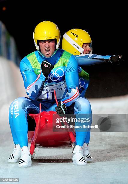 Andreas Linger and Wolfgang Linger of Austria react after their 2nd run in the Luge Doubles final on day 6 of the Vancouver 2010 Winter Olympics at...