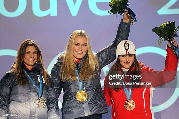 Julia Mancuso of the United States celebrates winning silver, Lindsey Vonn of the United States gold and Elisabeth Goergl of Austria bronze during...