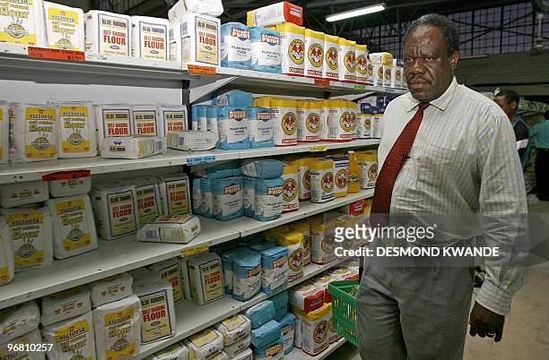 In Zimbabwe, morning chores mean good news' by Charlotte Plantive John Dzvinamurungu choses products in a supermarket in Zimbabwe's capital Harare on...