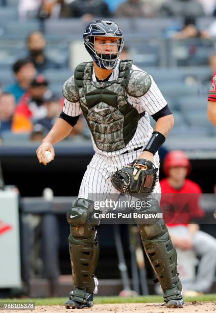 Catcher Gary Sanchez of the New York Yankees looks to throw to first base in an MLB baseball game against the Los Angeles Angels of Anaheim on May...