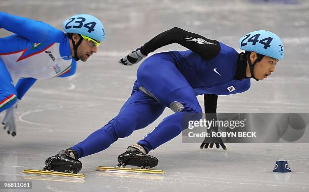 South Korean Si-bak Sung leads Nicola Rodigari of Italy during the men's 1,000m short-track heats at the Pacific Coliseum in Vancouver during the...