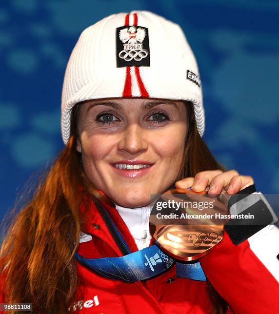 Elisabeth Goergl of Austria celebrates with her bronze medal during the medal ceremony for the Alpine Skiing Ladies Downhill on day 6 of the...