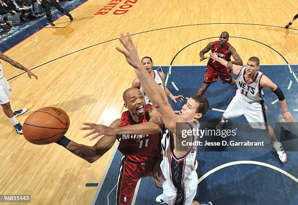 Rafer Alston of the Miami Heat shoots against Kris Humphries of the New Jersey Nets during the game on February 17, 2010 at the Izod Center in East...