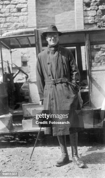 Full length portrait of President Franklin D. Roosevelt standing with cane outdoors, circa 1940s. .