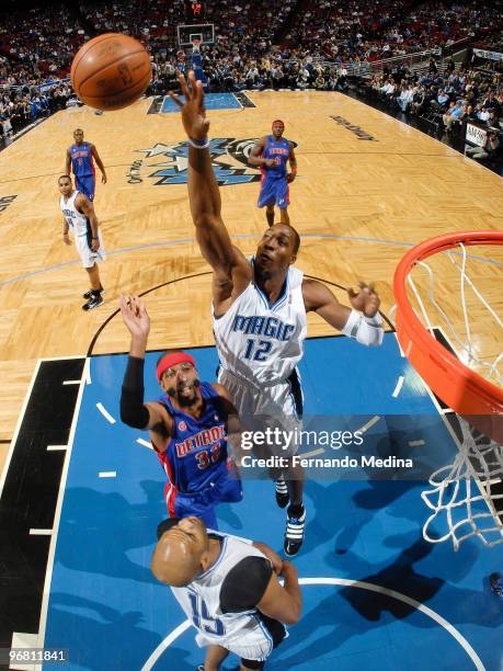 Dwight Howard of the Orlando Magic reaches to block a shot against Richard Hamilton of the Detroit Pistons during the game on February 17, 2010 at...
