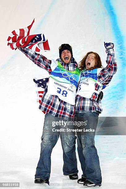 Shaun White of the United States reacts with fellow American Scott Lago after White wins the gold medal and Lago the bronze in the Snowboard Men's...