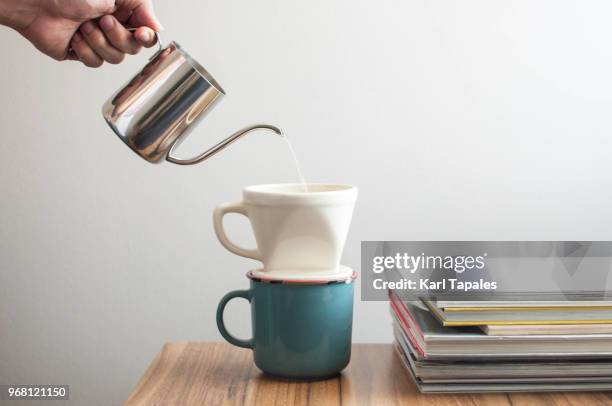 pouring a hot water over a drip coffee - brewed coffee stock-fotos und bilder