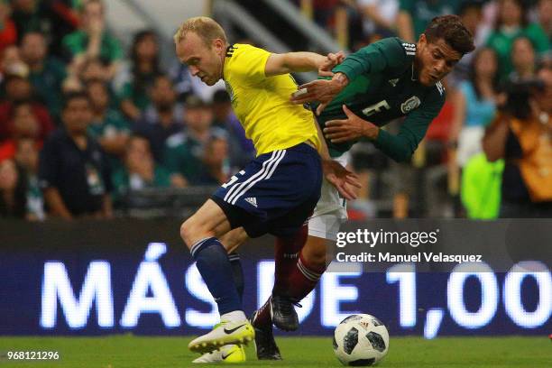 Jonathan Dos Santos of Mexico struggles for the ball against Dylan Mcgeouch of Scotland during the International Friendly match between Mexico and...