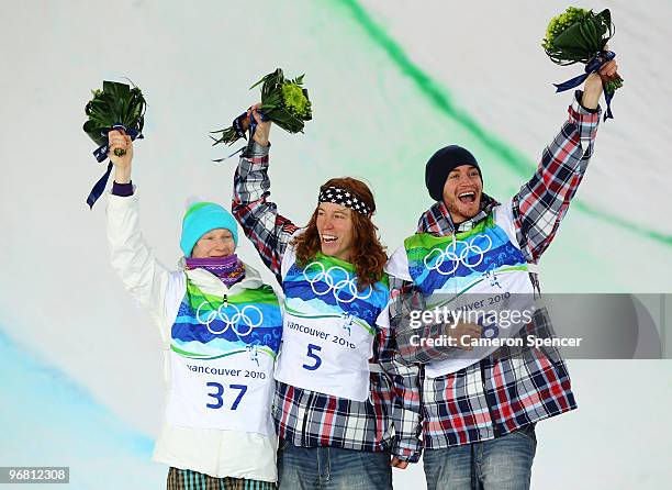 Peetu Piiroinen of Finland poses after winning the silver, Shaun White of the United States poses after winning the gold and Scott Lago after winning...