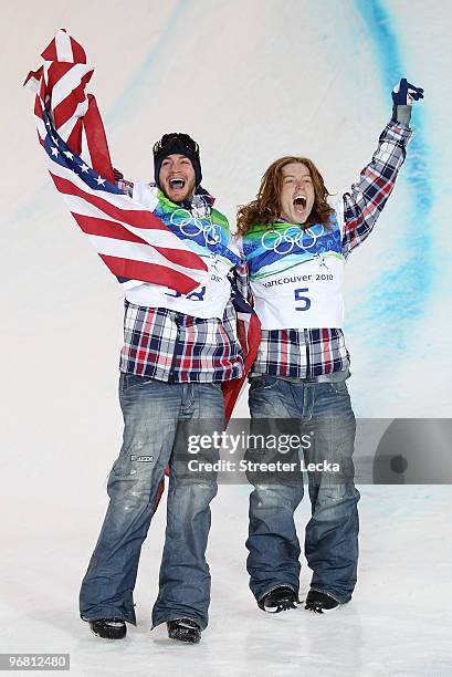 Shaun White of the United States reacts with fellow American Scott Lago after White wins the gold medal and Lago the bronze in the Snowboard Men's...