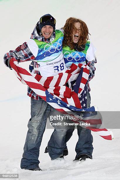 Shaun White of the United States reacts with fellow American Scott Lago after White wins the gold medal and Lago the bronze in the Snowboard Men's...